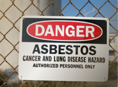Sign on a fence that reads "Danger Asbestos"