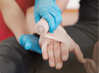 A hand being wrapped by a medical professional