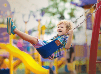 a child swinging happily on a swing