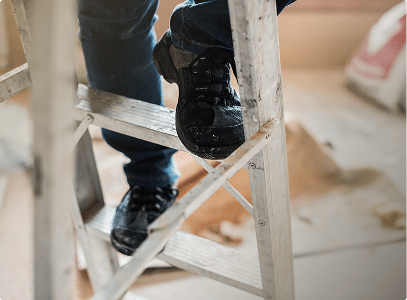 Close up of two boots climbing a ladder