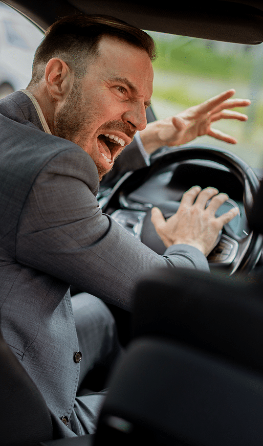 An angry driver screaming and honking on the horn