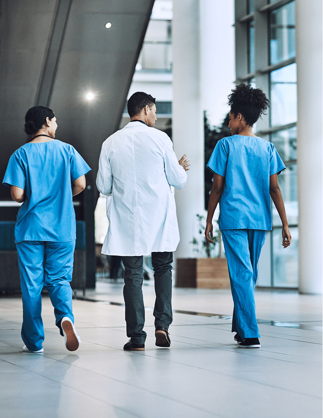 Medical professionals walking way from the camera
