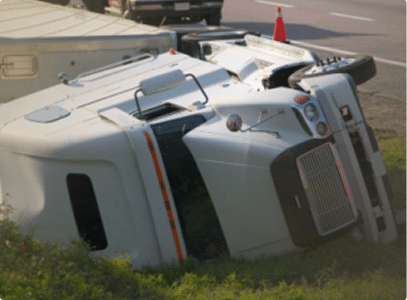 a white semi truck flipped on its side