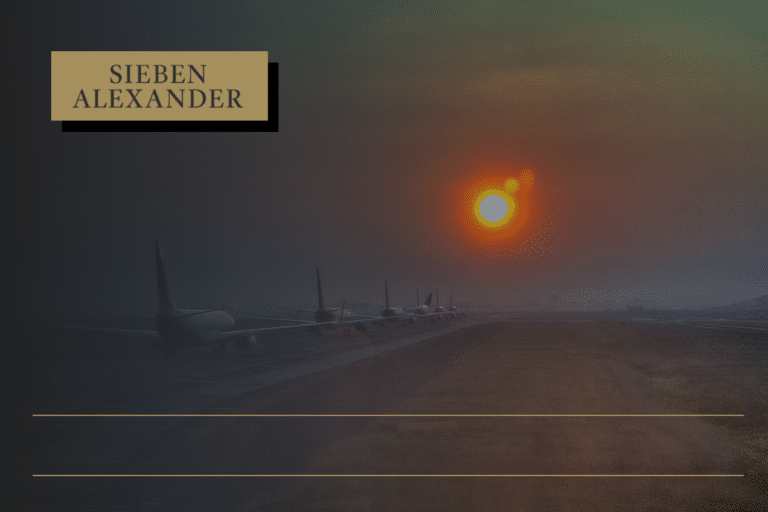 Airplanes lined up on a runway at sunset